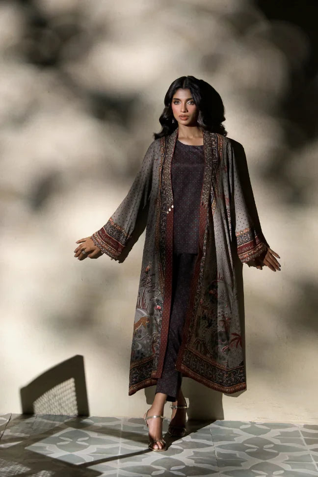 Woman wearing Manto's long, patterned coat in an indoor setting, featuring Urdu calligraph & Illustration