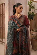 Woman wearing a traditional outfit with intricate patterns in a home setting