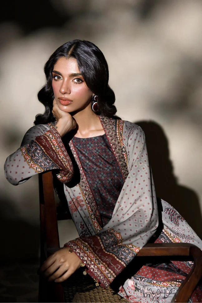 Woman wearing Manto's long, patterned coat in an indoor setting, featuring Urdu calligraph & Illustration